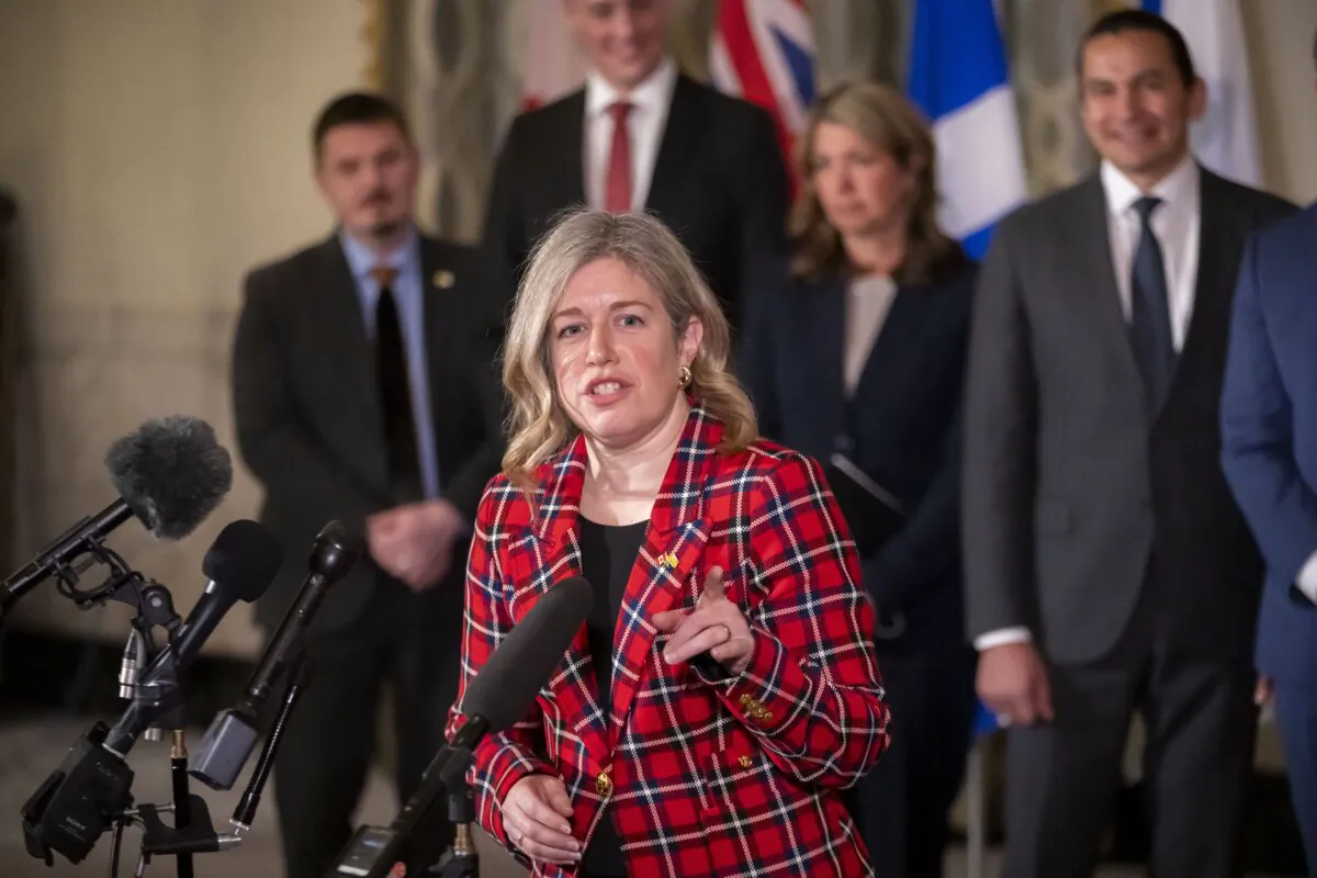 Premier of New Brunswick Susan Holt, accompanied by other Council of the Federation members, speaks to reporters at the Mayflower Hotel in Washington, on Feb. 12, 2025. (The Canadian Press/AP-Ben Curtis) 