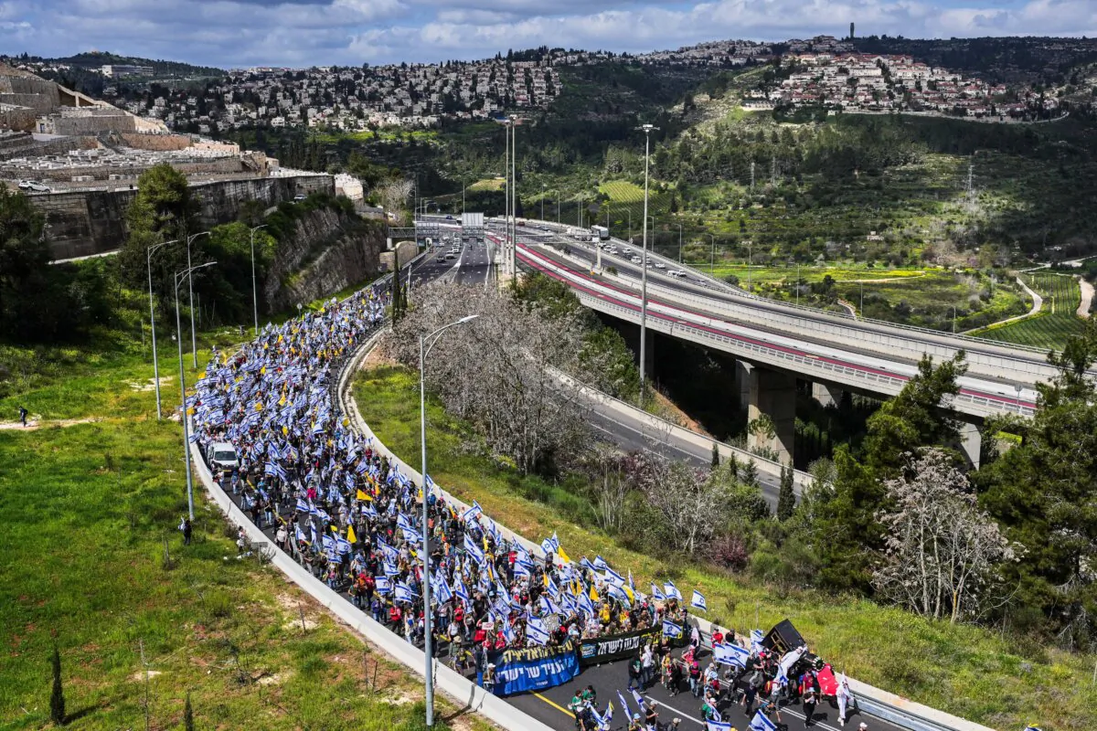 Israelis march on a highway toward Jerusalem to protest Prime Minister Benjamin Netanyahu's plans to dismiss the head of the Shin Bet internal security service, on March 19, 2025. (Ohad Zwigenberg/AP Photo)