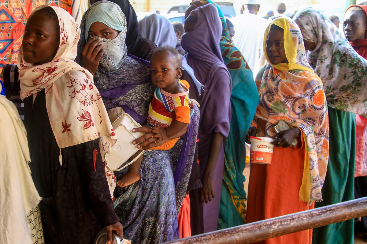 Sudanese line up to collect a charity "Iftar" fast breaking meal in Omdurman, on Mar. 19, 2025, during Ramadan. (Ebrahim Hamid/AFP via Getty Images)