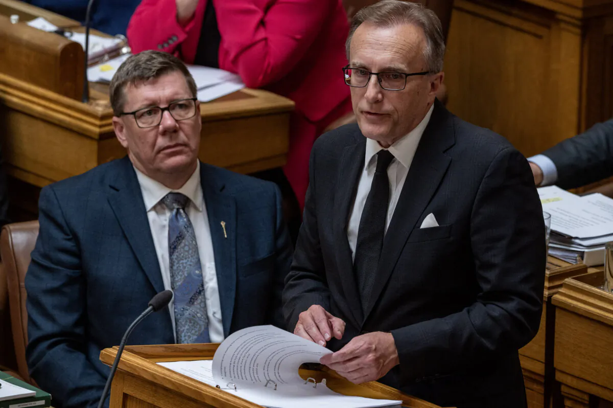 Saskatchewan Minister of Finance Jim Reiter (R) presents the provincial budget as Premier Scott Moe looks on in Regina on March 19, 2025. (The Canadian Press/Liam Richards)