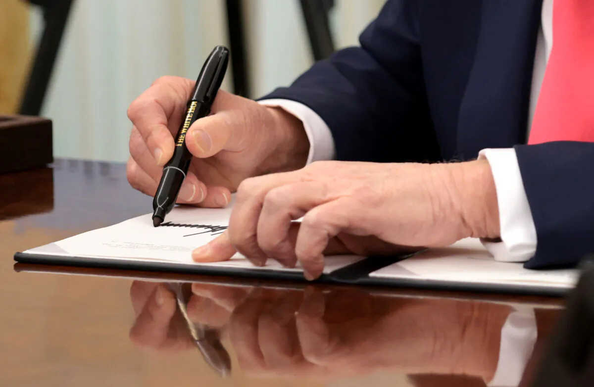 President Donald Trump signs executive orders in the Oval Office of the White House on March 6, 2025. (Alex Wong/Getty Images)