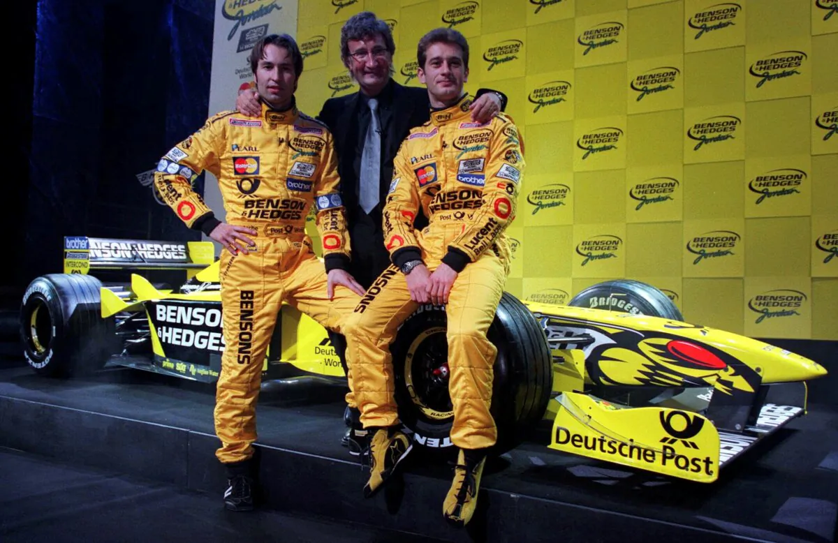 Eddie Jordan (C) poses for a photo with Heinz-Harald Frentzen and Jarno Trulli on Jan. 31, 2000. (Matthew Fearn/PA via AP)