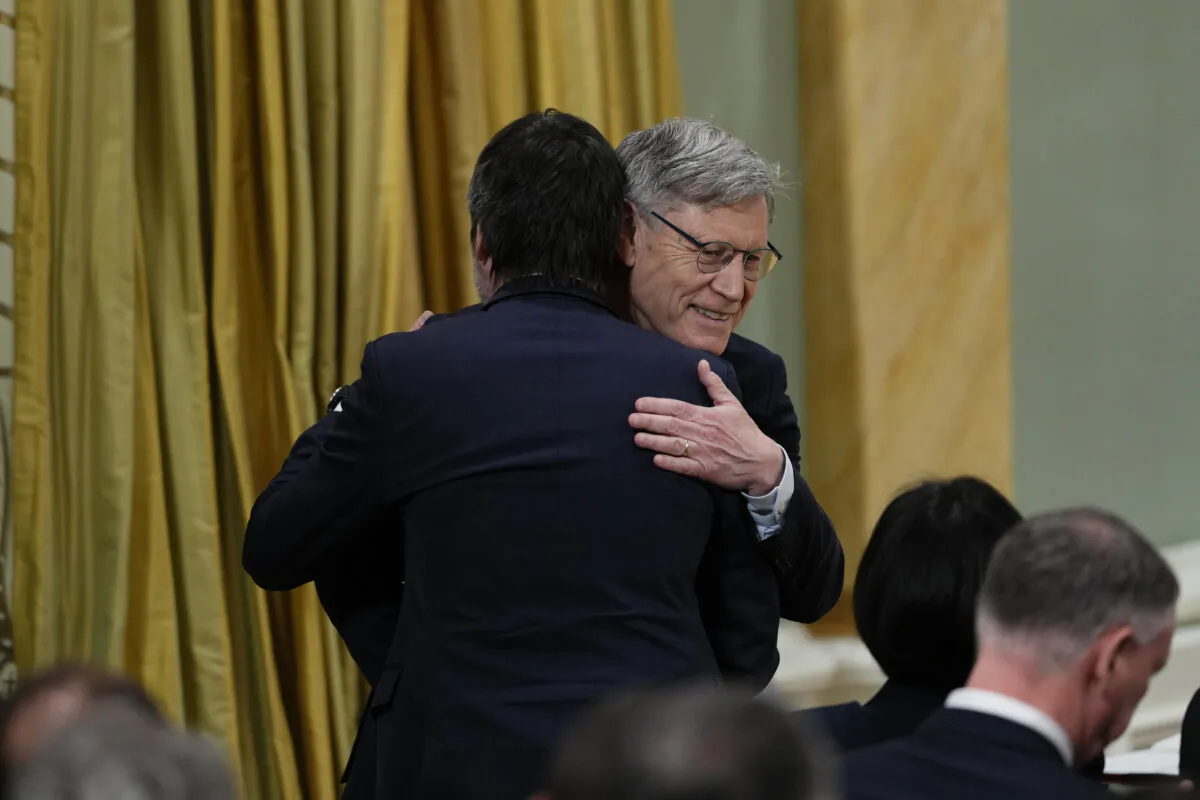 Minister of Environment and Climate Change Terry Duguid (R), embraces Steven Guilbeault, minister of Canadian Culture and Identity, after being sworn in at a cabinet ceremony at Rideau Hall in Ottawa on March 14, 2025. (The Canadian Press/Justin Tang)
