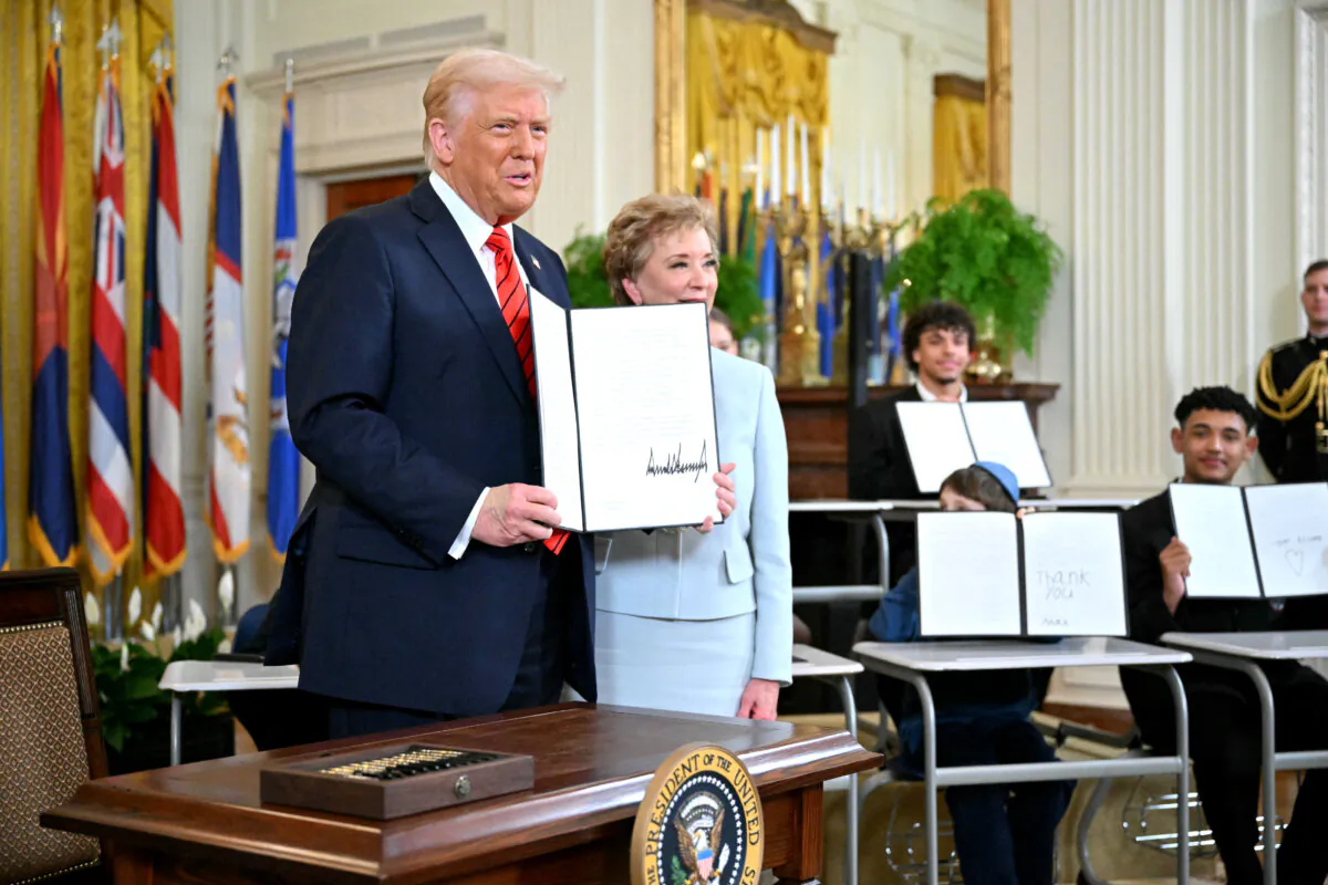 President Donald Trump holds an executive order after signing it alongside Secretary of Education Linda McMahon (R) in the East Room of the White house on March 20, 2025. (Mandel Ngan/AFP via Getty Images)