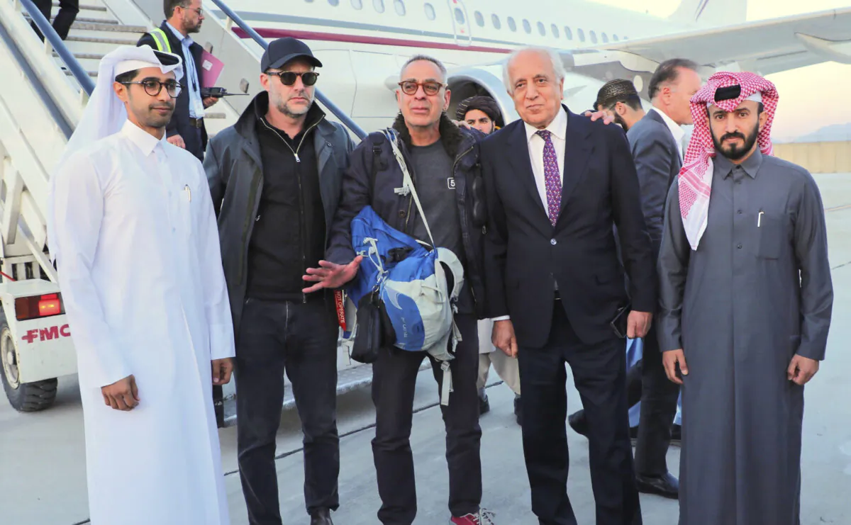 George Glezmann (C) poses with Adam Boehler (2nd L) and Zalmay Khalilzad (2nd R) and Qatari diplomats in Kabul, Afghanistan, on March 20, 2025, before departing to Doha, Qatar. (Qatar Ministry of Foreign Affairs via AP)
