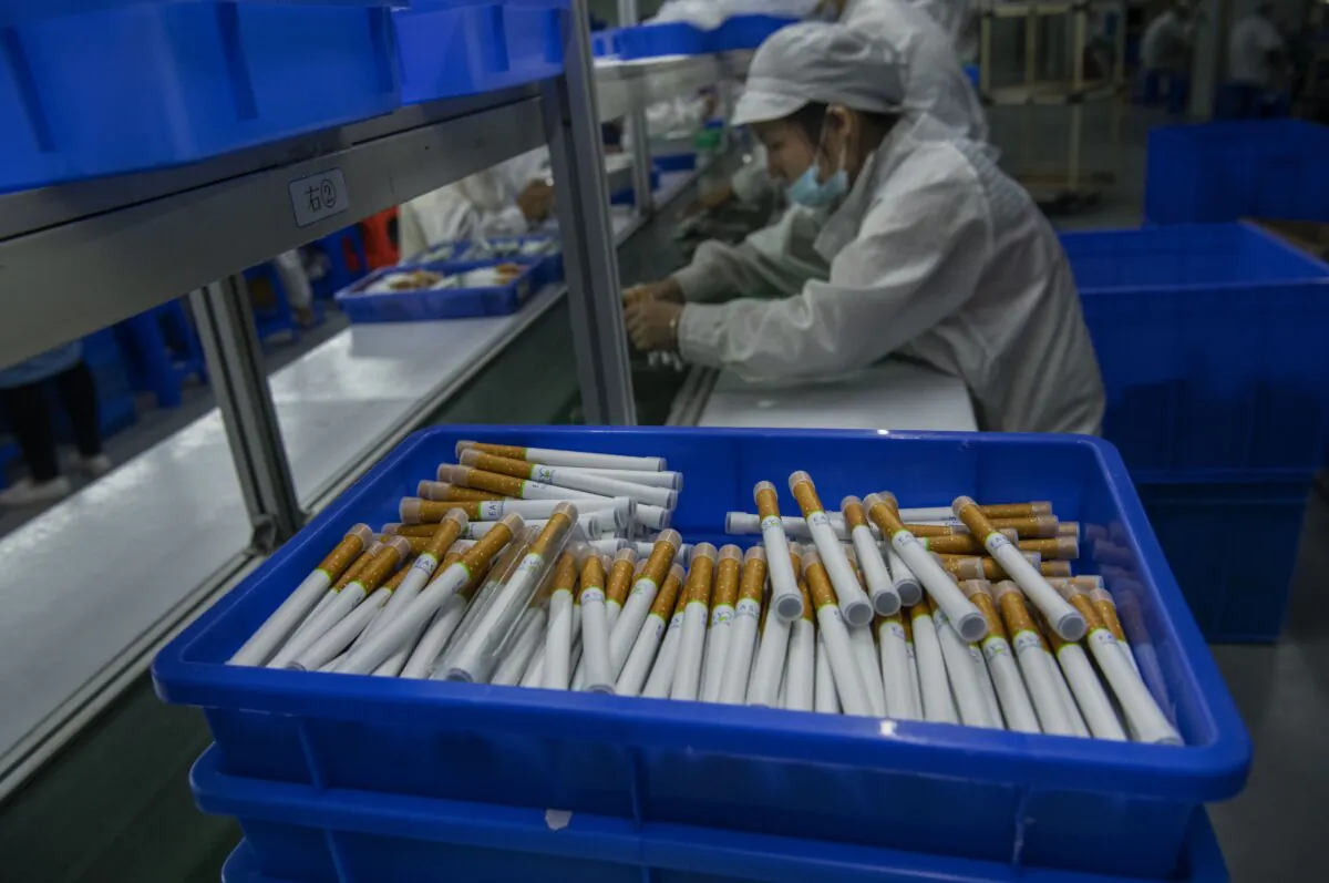 Workers box e-cigarettes on the production line in Shenzhen, China, on Sept. 25, 2019. (Kevin Frayer/Getty Images)