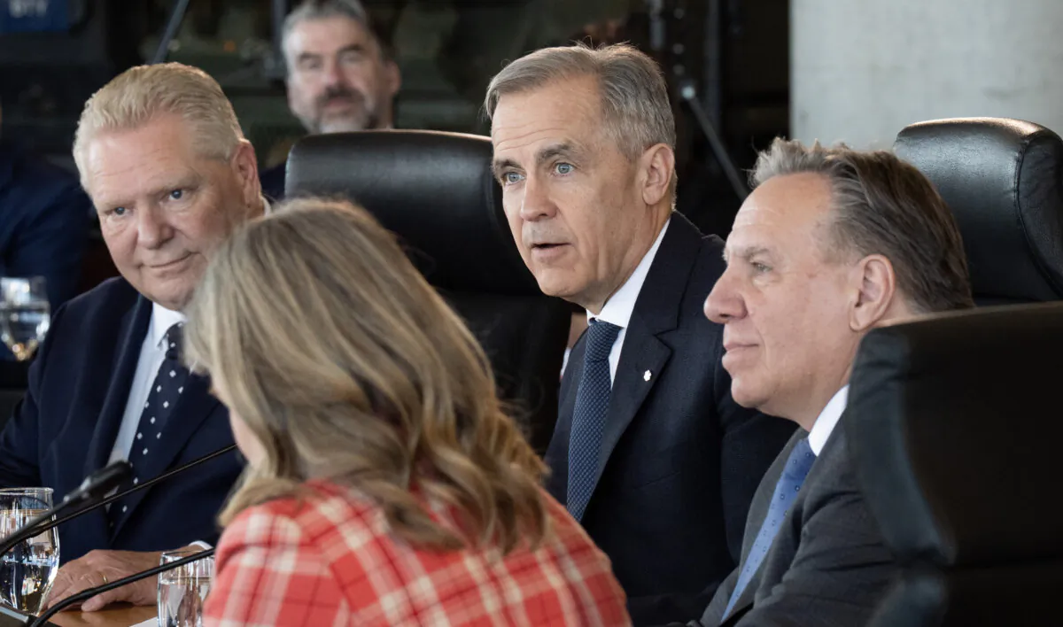 Prime Minister Mark Carney (C), Ontario Premier Doug Ford (L), and Premier of Quebec Francois Legault (R) take part in the First Minister Meeting at the National War Museum in Ottawa on March 21, 2025. (Adrian Wyld/The Canadian Press)
