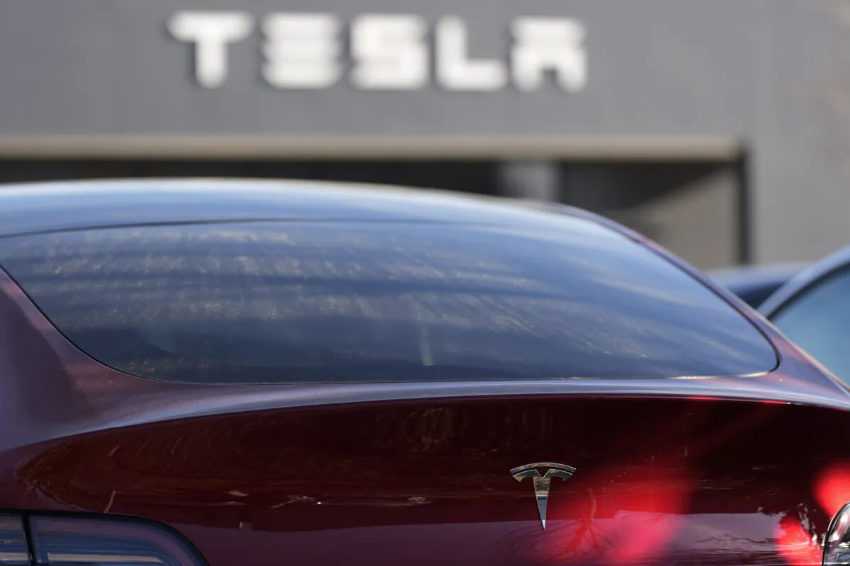 A Tesla Model Y and other Tesla vehicles sit at a dealership in Kennesaw, Ga., on Mar. 19, 2025. (AP Photo/Mike Stewart)