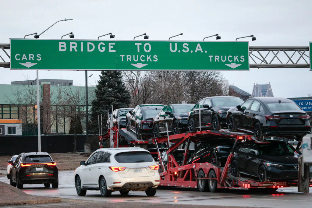 A car hauler heads to cross the Ambassador Bridge between Windsor, Canada, and Detroit, Mich., on the first day of President Donald Trump's new 25 percent tariffs on goods from Canada and Mexico on March 4, 2025. (Bill Pugliano/Getty Images)