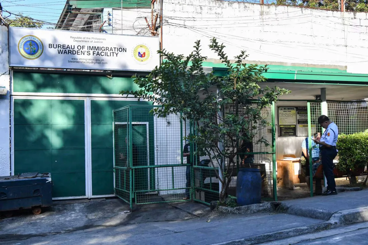 Security guards of the Philippine Bureau of Immigration stand in front of a detention facility in Taguig City, Philippines, on Feb. 1, 2023. (Ted Aljibe/AFP via Getty Images)