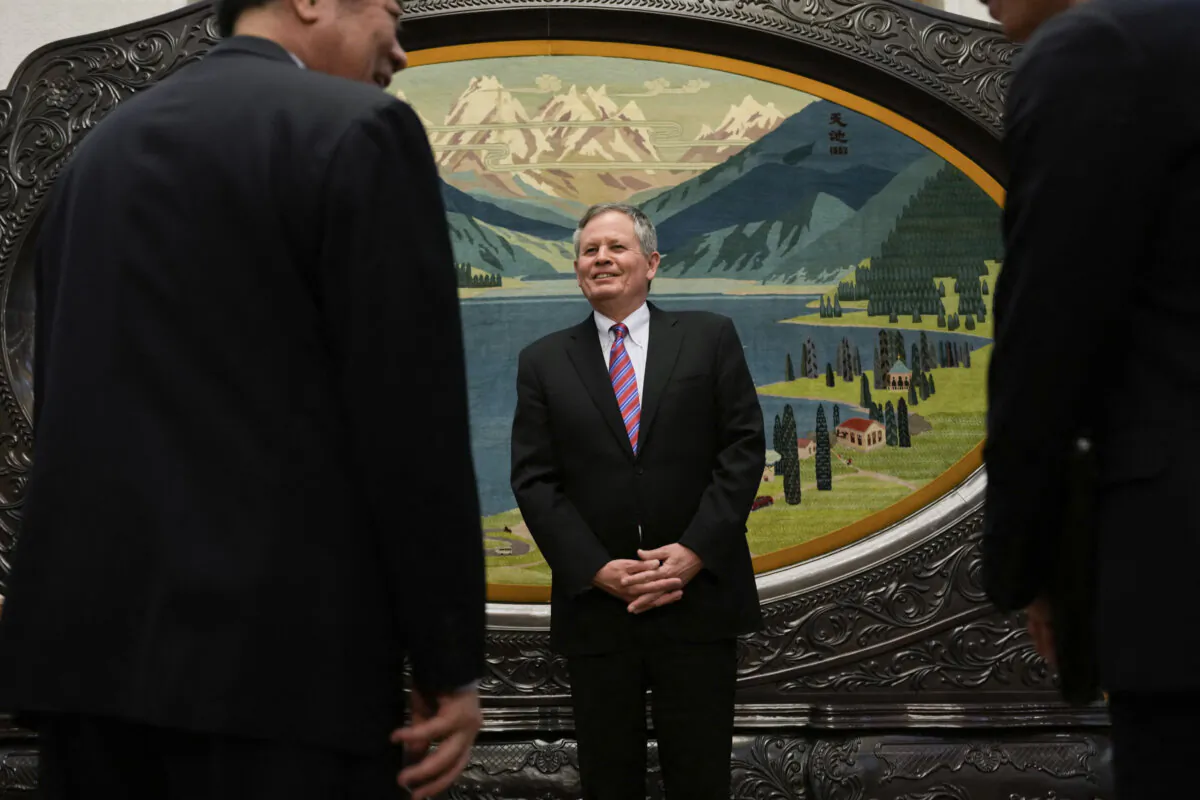 Sen. Steve Daines (R-Mont.) (C) greets Chinese Vice Premier He Lifeng (L) before their meeting held in the Xinjiang Room at the Great Hall of the People in Beijing on March 22, 2025. (Ng Han Guan/AFP via Getty Images)