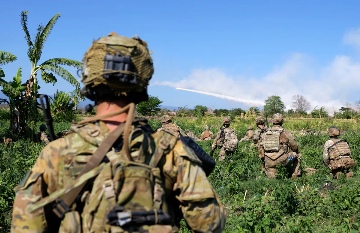 Australian and United States Army soldiers watch a United States Army M142 High Mobility Artillery Rocket System (HIMARS) fire in Puslatpur, Indonesia during Exercise Super Garuda Shield 2023. (Courtesy of the Australian Defence Force).