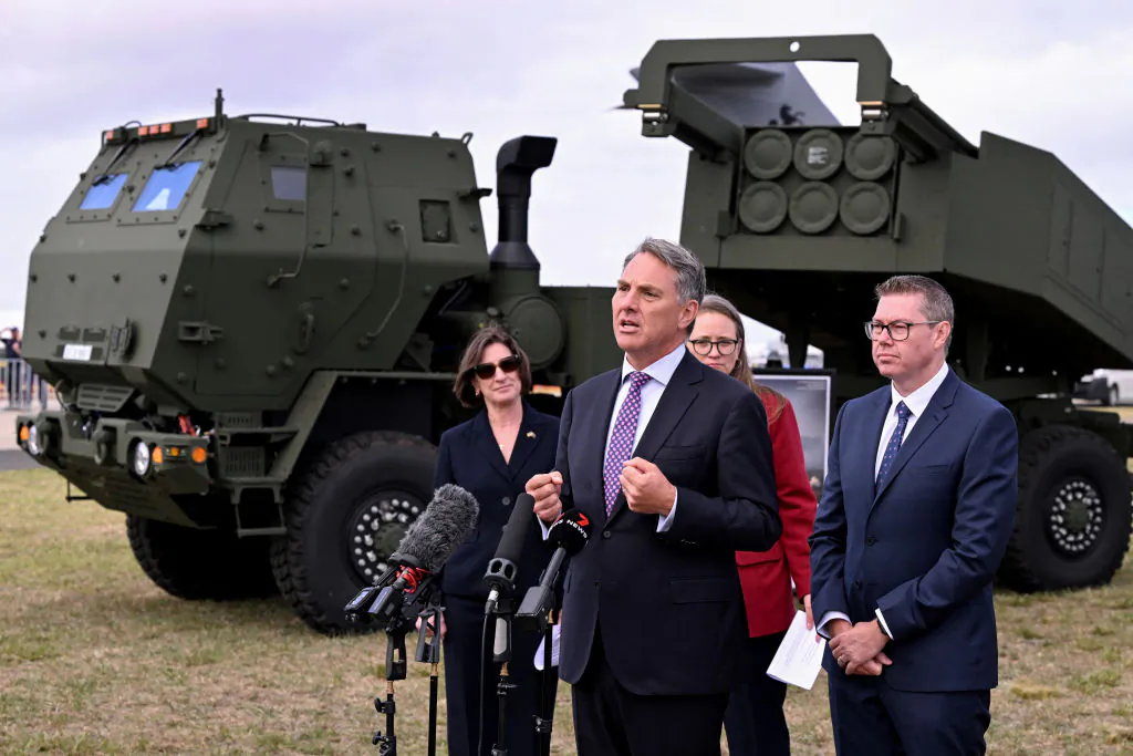 Australia's Minister of Defence Richard Marles (C) and Minister of Defence Industry Pat Conroy (R) announce the accelerated delivery of Australia's first High Mobility Artillery Rocket System (HIMARS) at the Australian International Airshow in Avalon in Victoria, Australia on March 24, 2025. (William West/AFP via Getty Images)