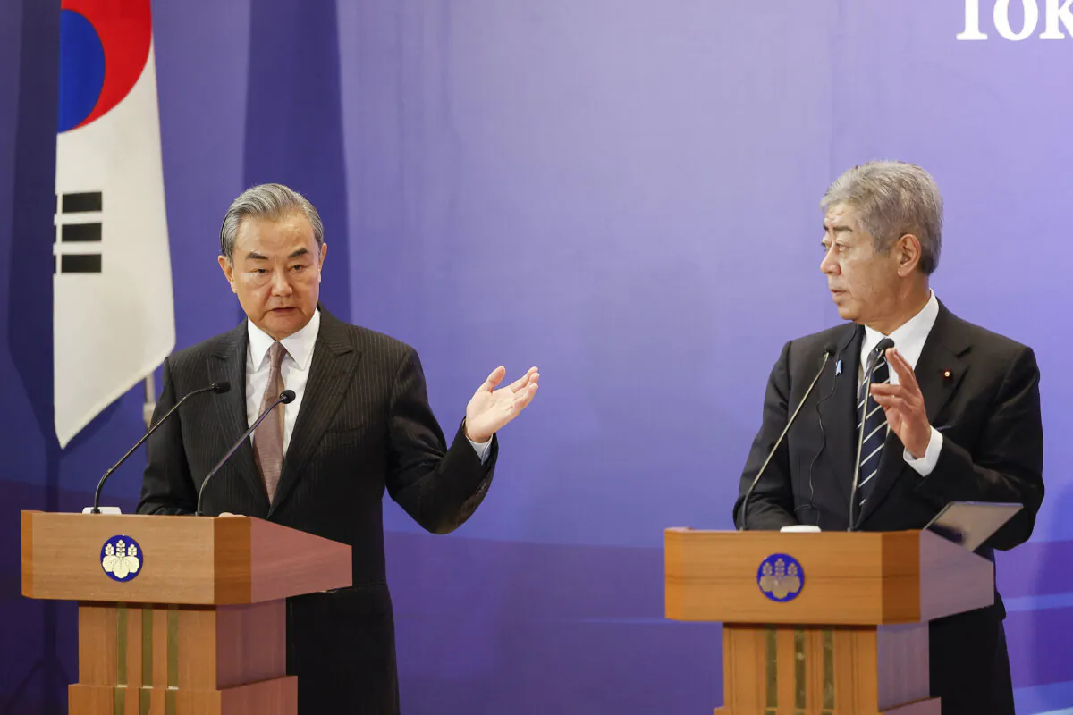 Chinese Foreign Minister Wang Yi (L) and Japanese Foreign Minister Takeshi Iwaya hold a joint press conference after their meeting during the 11th Trilateral Foreign Minister's Meeting in Tokyo on March 22, 2025. (Rodrigo Reyes Marin/Pool/AFP via Getty Images)