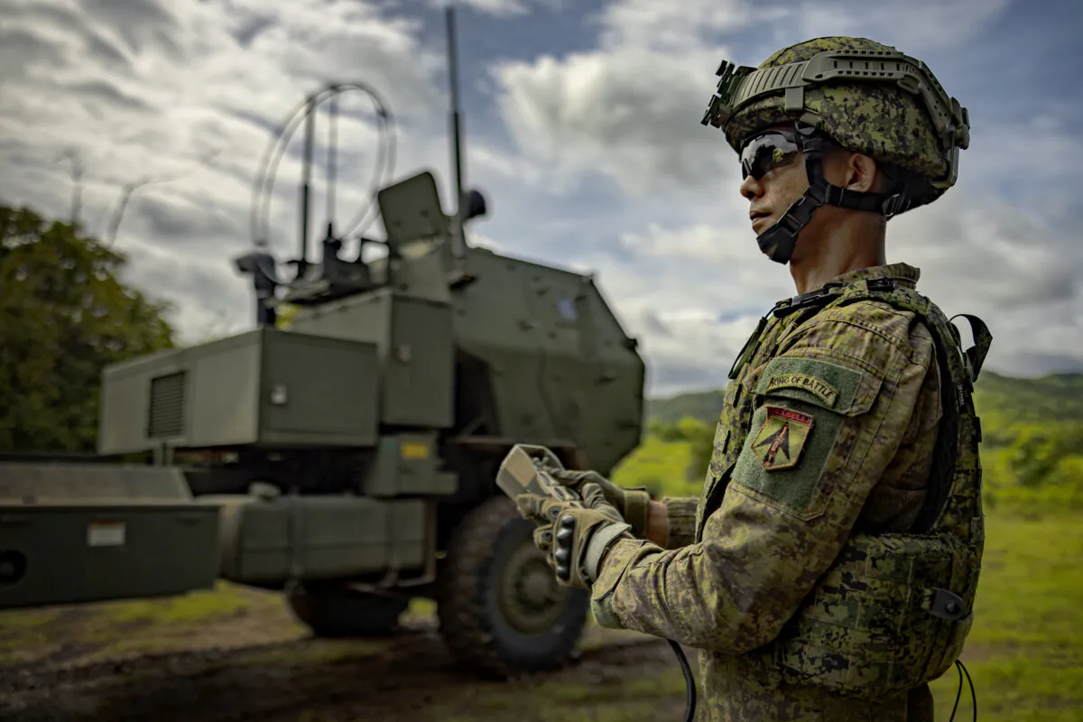 A Filipino soldier uses a controller to deploy a High Mobility Artillery Rocket System (HIMARS), as part of joint army-to-army drills between the United States and the Philippines, in Laur, Nueva Ecija province, Philippines, on Aug. 9, 2024. (Ezra Acayan/Getty Images)