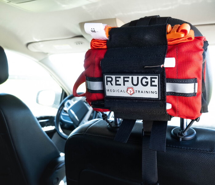 (Red TravelFAK Mounted on Headrest. - Refuge Medical)