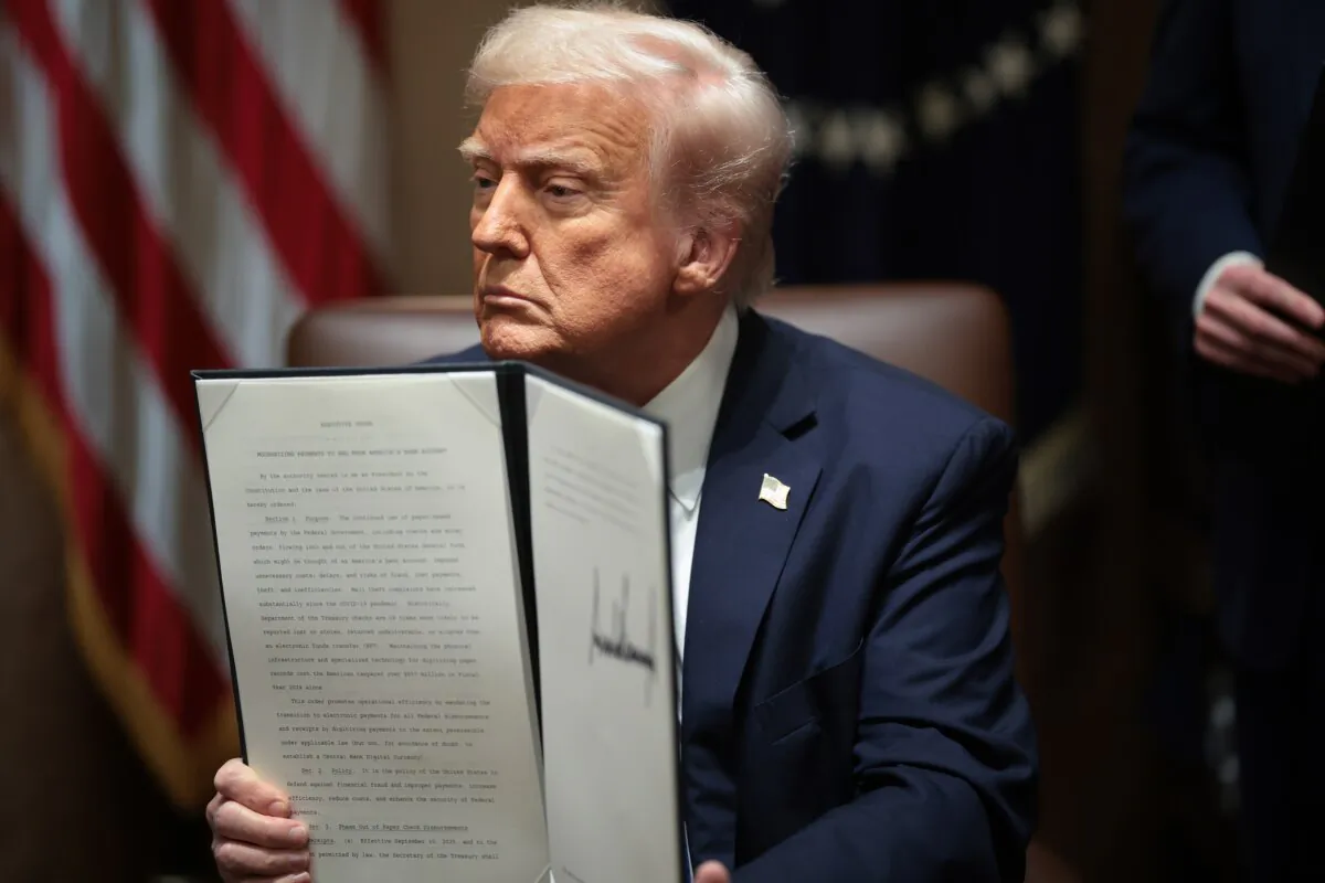 President Donald Trump holds an order at the White House in Washington on March 25, 2025. (Win McNamee/Getty Images)