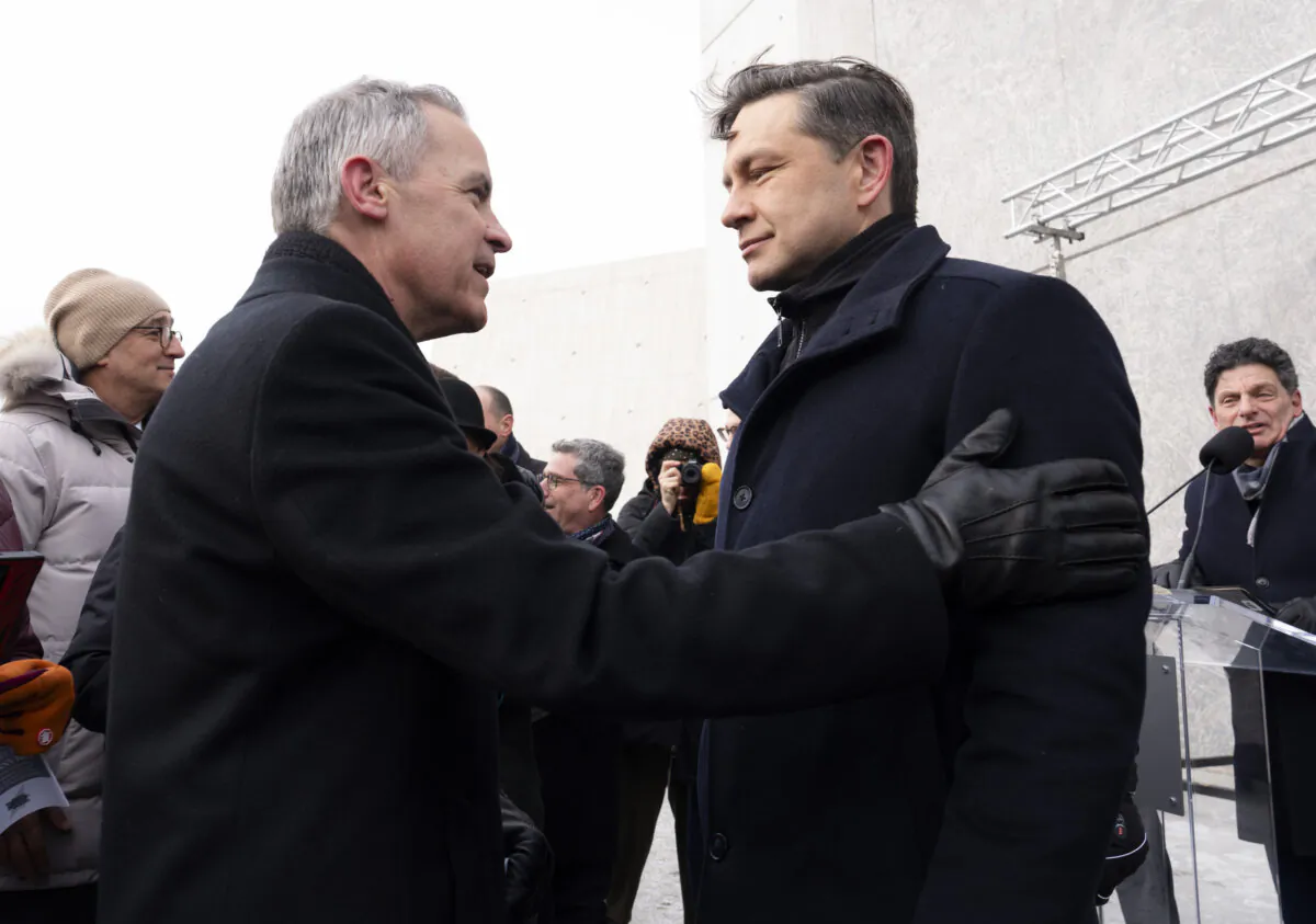 Then-Liberal Leadership candidate Mark Carney speaks with Conservative Leader Pierre Poilievre before a ceremony at the National Holocaust Monument in Ottawa, on Jan 27, 2025. (The Canadian Press/Adrian Wyld)