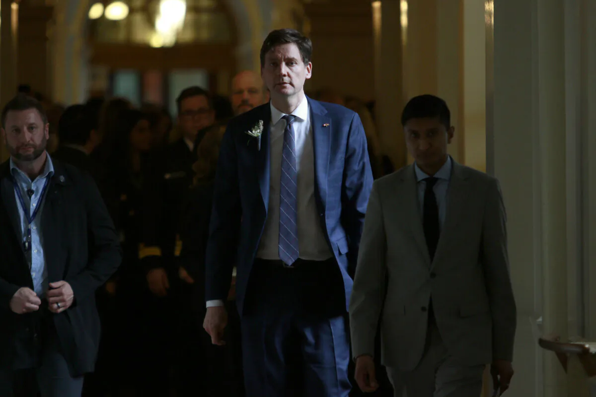 Premier David Eby walks back to his office following the throne speech at the legislature in Victoria, on Feb. 18, 2025. (The Canadian Press/Chad Hipolito)