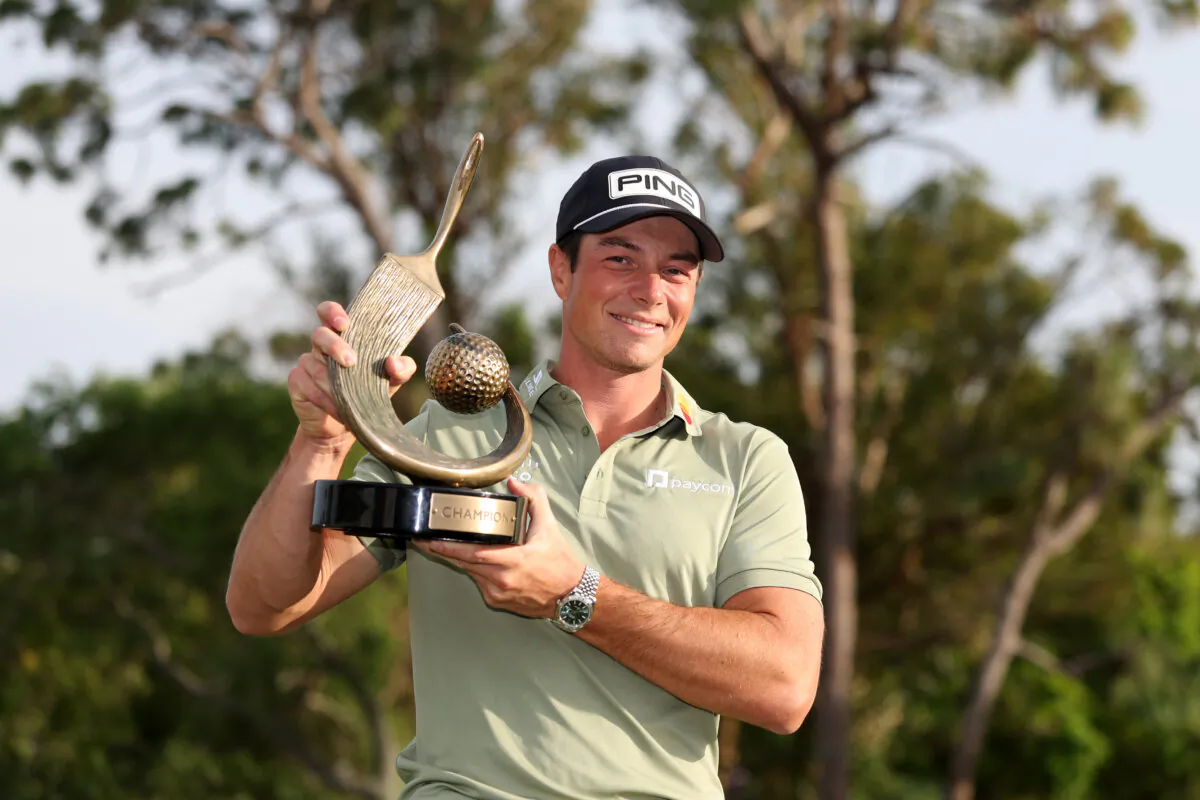 Viktor Hovland of Norway poses with the trophy after putting in to win on the 18th green during the final round of the Valspar Championship 2025 at Innisbrook Resort and Golf Club in Palm Harbor, Florida, on March 23, 2025. (Brennan Asplen/Getty Images)
