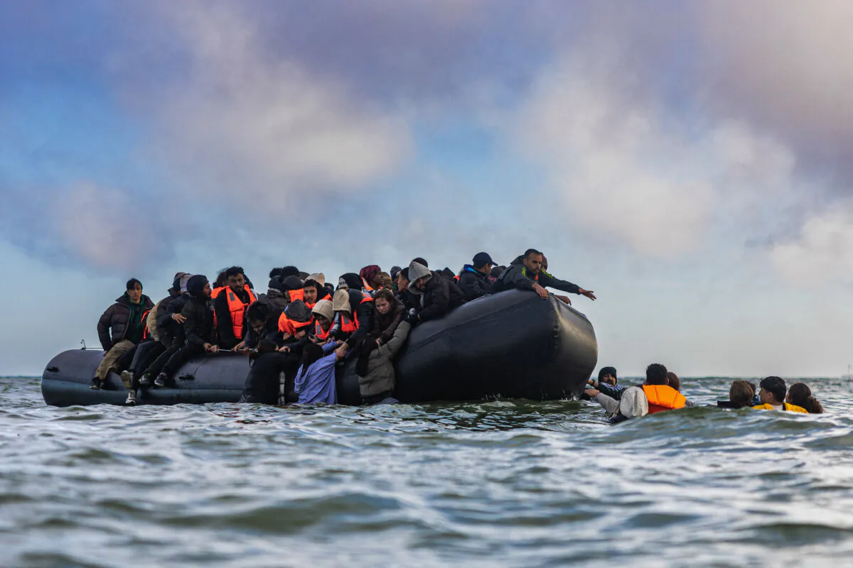Migrants board a smuggler's boat in an attempt to cross the English Channel, off the beach near Gravelines, north of France, on March 26, 2025. (Sameer Al-Doumy/AFP via Getty Images)