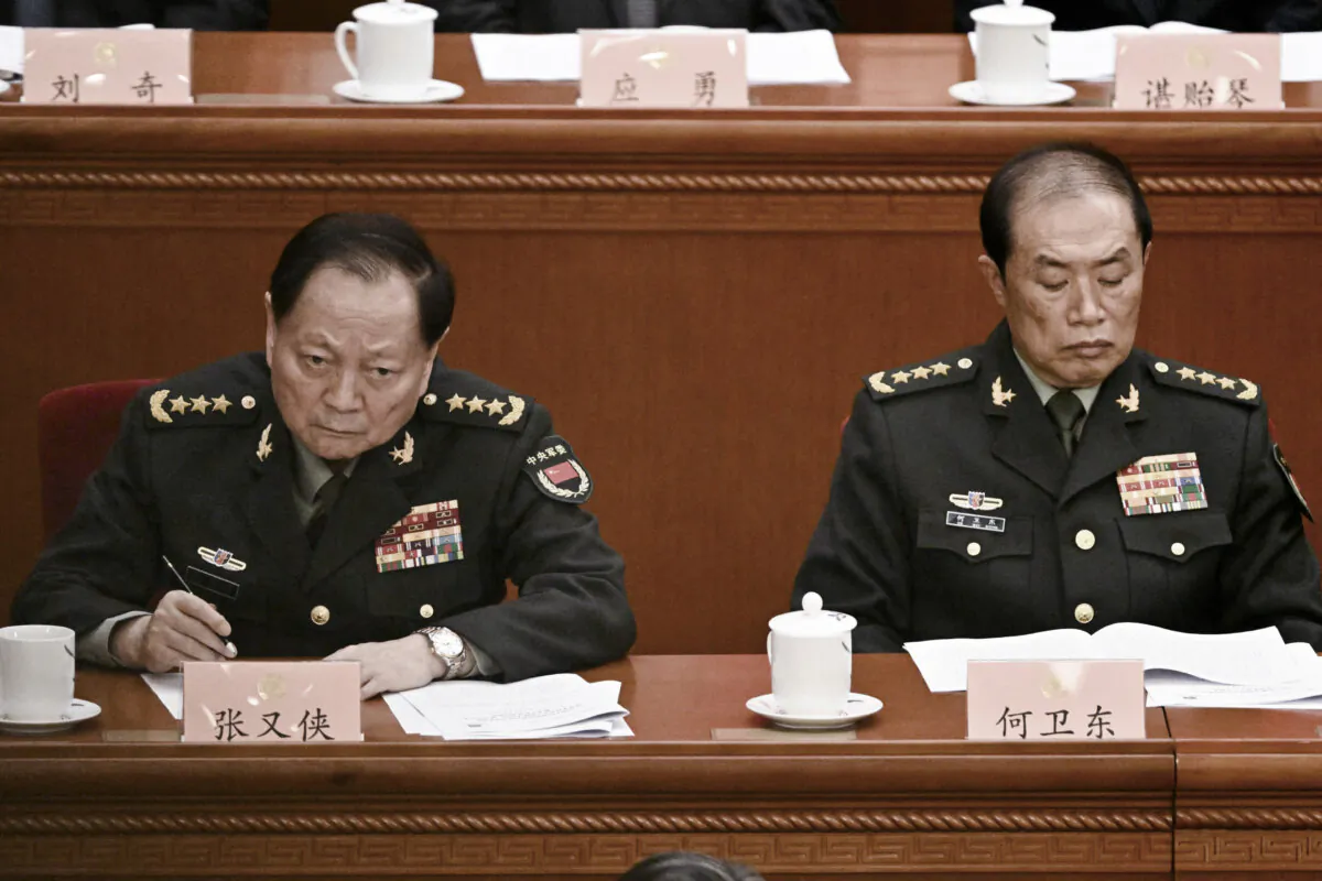 Gen. He Weidong (R), second-ranked vice chairman of China's Central Military Commission (CMC), and Zhang Youxia, first-ranked vice chairman of the CMC, attend the opening ceremony of the Chinese People's Political Consultative Conference at the Great Hall of the People in Beijing on March 4, 2025. (Pedro Pardo/AFP via Getty Images)