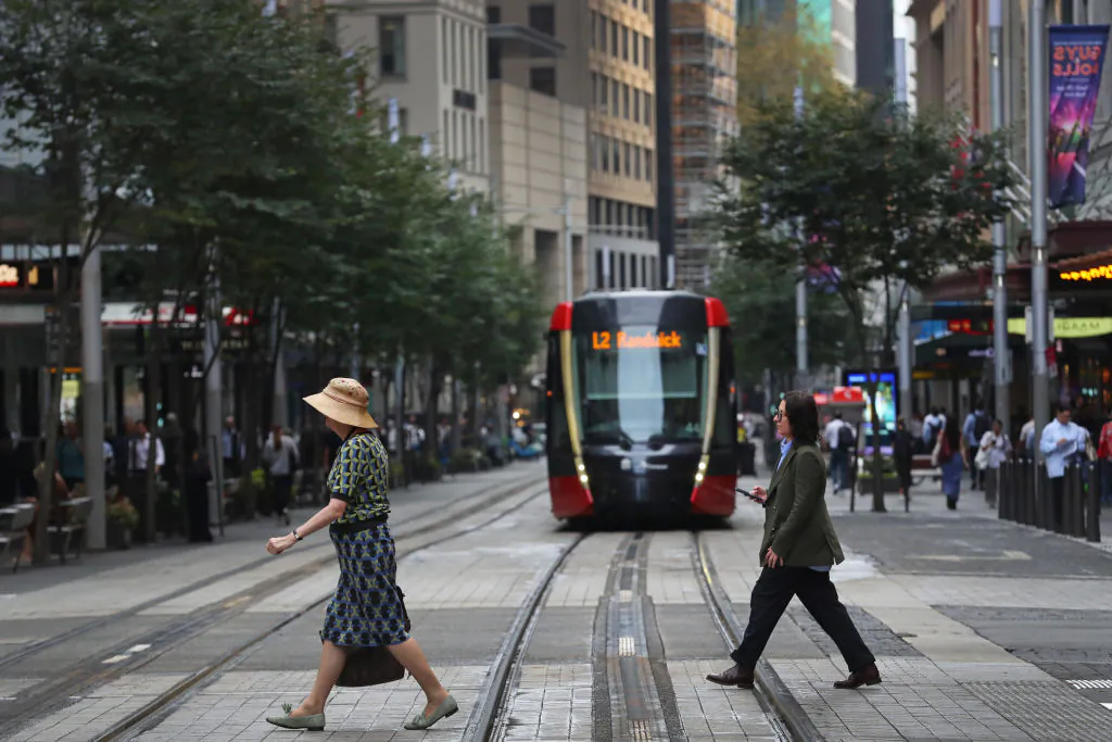 Pedestrians move across George Street in the central business district (CBD) in Sydney, Australia, on March 26, 2025. (Lisa Maree Williams/Getty Images)