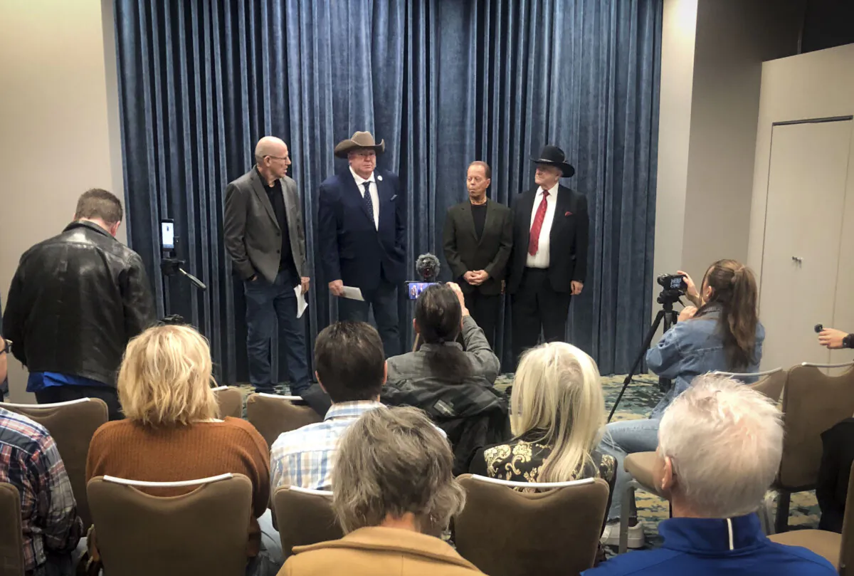 Alberta Prosperity Project CEO Mitch Sylvestre (L) holds a press conference with (2nd L–R) lawyer Jeffrey Rath, Dr. Dennis Modry, and former MP LaVar Payne in Calgary on March 26, 2025. (The Epoch Times)