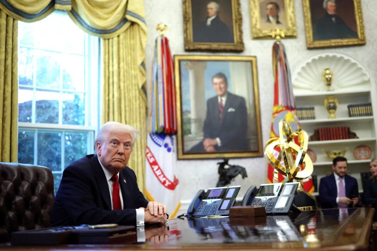 President Donald Trump prepares to sign an executive order in the Oval Office of the White House on March 26, 2025. (Win McNamee/Getty Images)