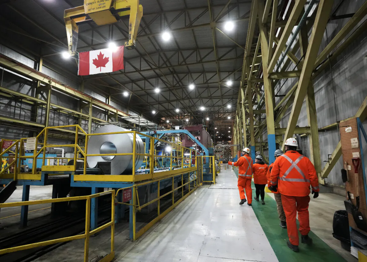 Steel workers are seen at work at the ArcelorMittal Dofasco steel plant in Hamilton, Ont., on March 12, 2025. (The Canadian Press/Nathan Denette)
