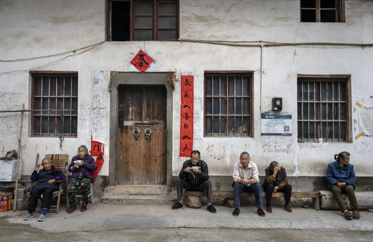 Villagers eat together outside a house in a farming community in She county, Anhui Province, southern China, on May 12, 2023. (Kevin Frayer/Getty Images)