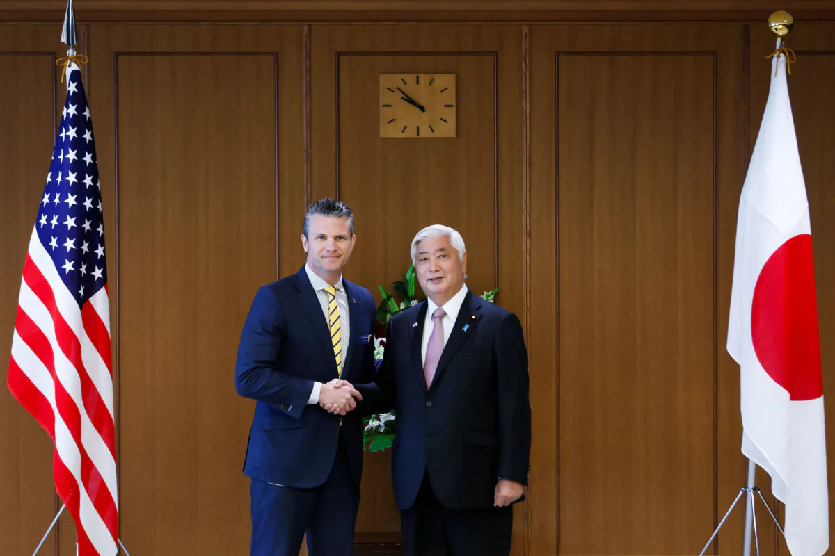 Pete Hegseth, U.S. secretary of defense, and Gen Nakatani, Japan's defense minister, shake hands while posing for photographs prior to their meeting at the Ministry of Defense in Tokyo on March 30, 2025. (Kiyoshi Ota/Pool via Reuters)