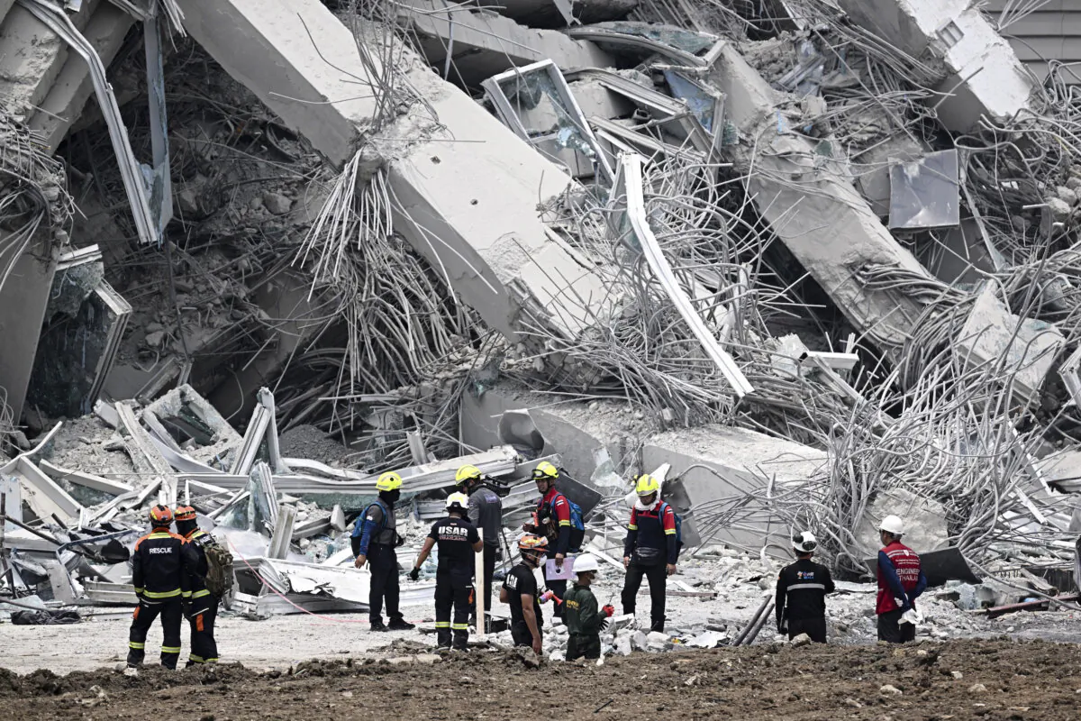 A day after an earthquake struck central Burma and Thailand, rescue workers survey the site of a building collapse in Bangkok, on March 29, 2025. (Lillian Suwanrumpha/AFP via Getty Images)