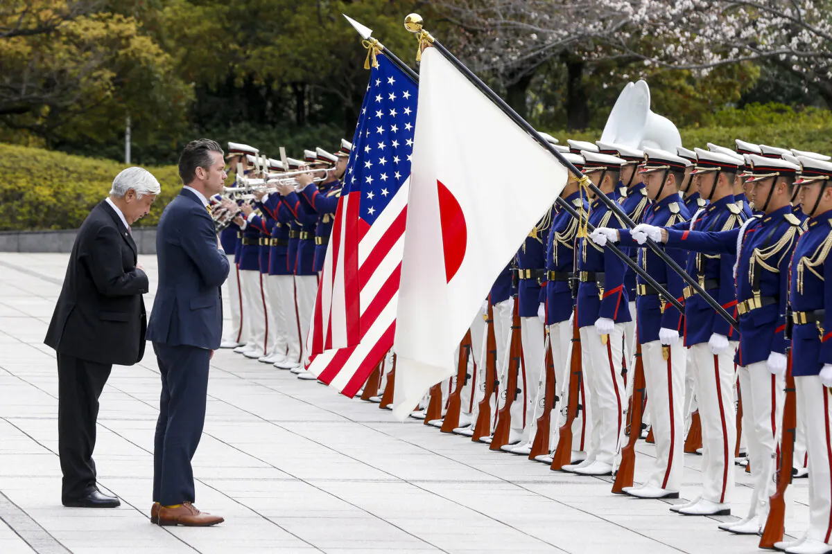 Japanese Defense Minister Gen Nakatani (L) and U.S. Defense Secretary Pete Hegseth review an honor guard during a welcome ceremony at the Ministry of Defense in Tokyo on March 30, 2025. (Kiyoshi Ota/AFP/Pool/AFP via Getty Images)