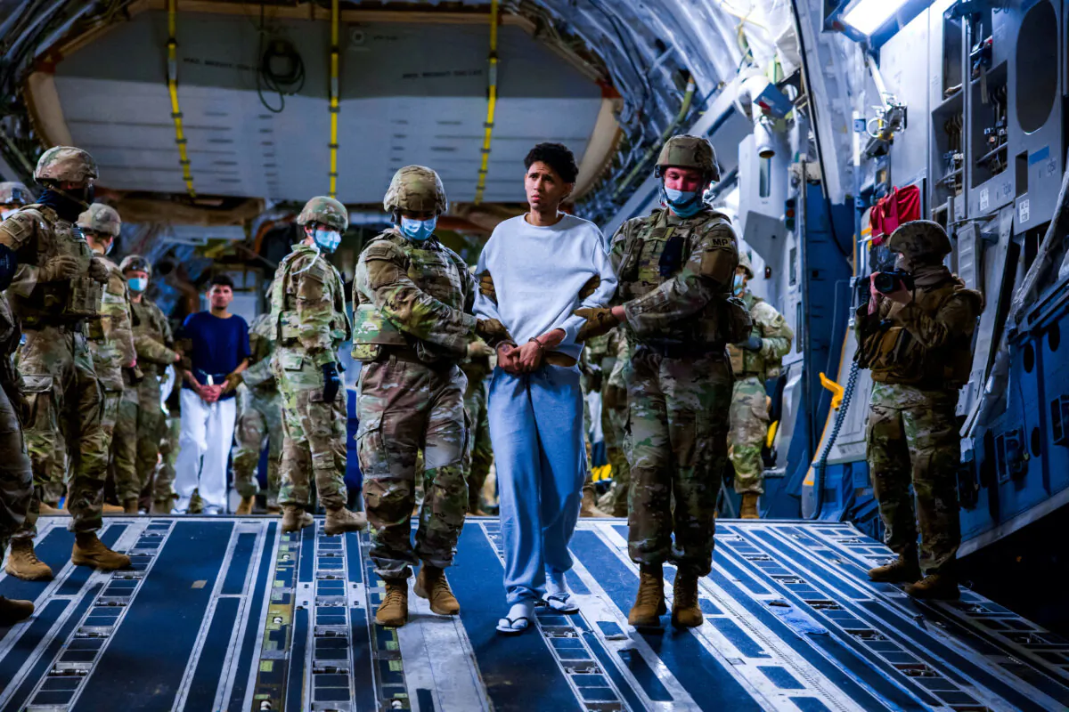 US military personnel escort alleged members of the Venezuelan gang Tren de Aragua and the MS-13 gang recently deported by the U.S. government to be imprisoned in the Terrorism Confinement Center (CECOT) prison as part of an agreement with the Salvadoran government, in San Luis Talpa, El Salvador, on March 30, 2025. (Secretaria de Prensa de la Presidencia/Handout via Reuters)