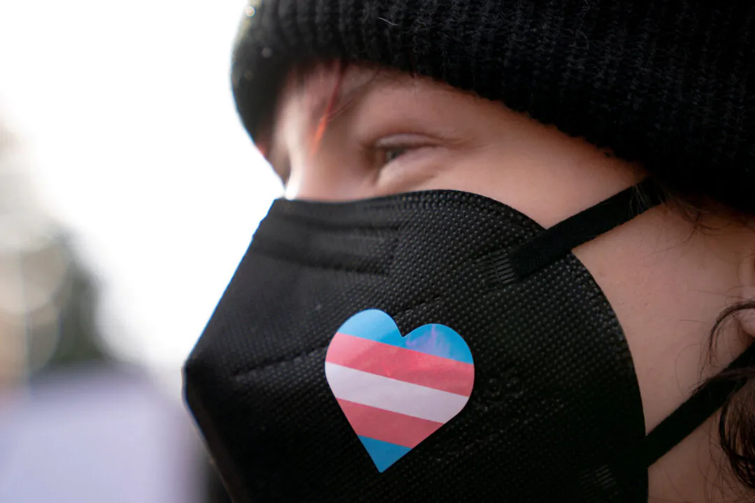 A person wears a transgender pride sticker during a rally in Seattle on Feb. 8, 2025. (David Ryder/Reuters)