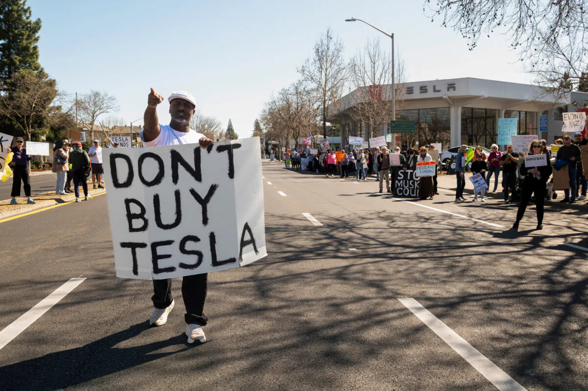 People protest against Tesla and Elon Musk outside of a Tesla dealership in Palo Alto, Calif. on, March 8, 2025. (Reuters/Laure Andrillon/File Photo)