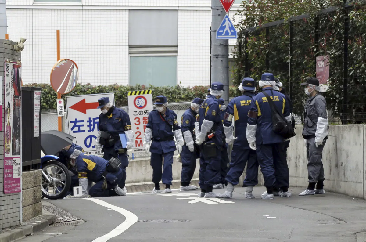 Japanese police investigators at the scene of the murder of YouTuber Airi Sato in the Takadanobaba district of Tokyo on March 11, 2025. (Kyodo News via AP)