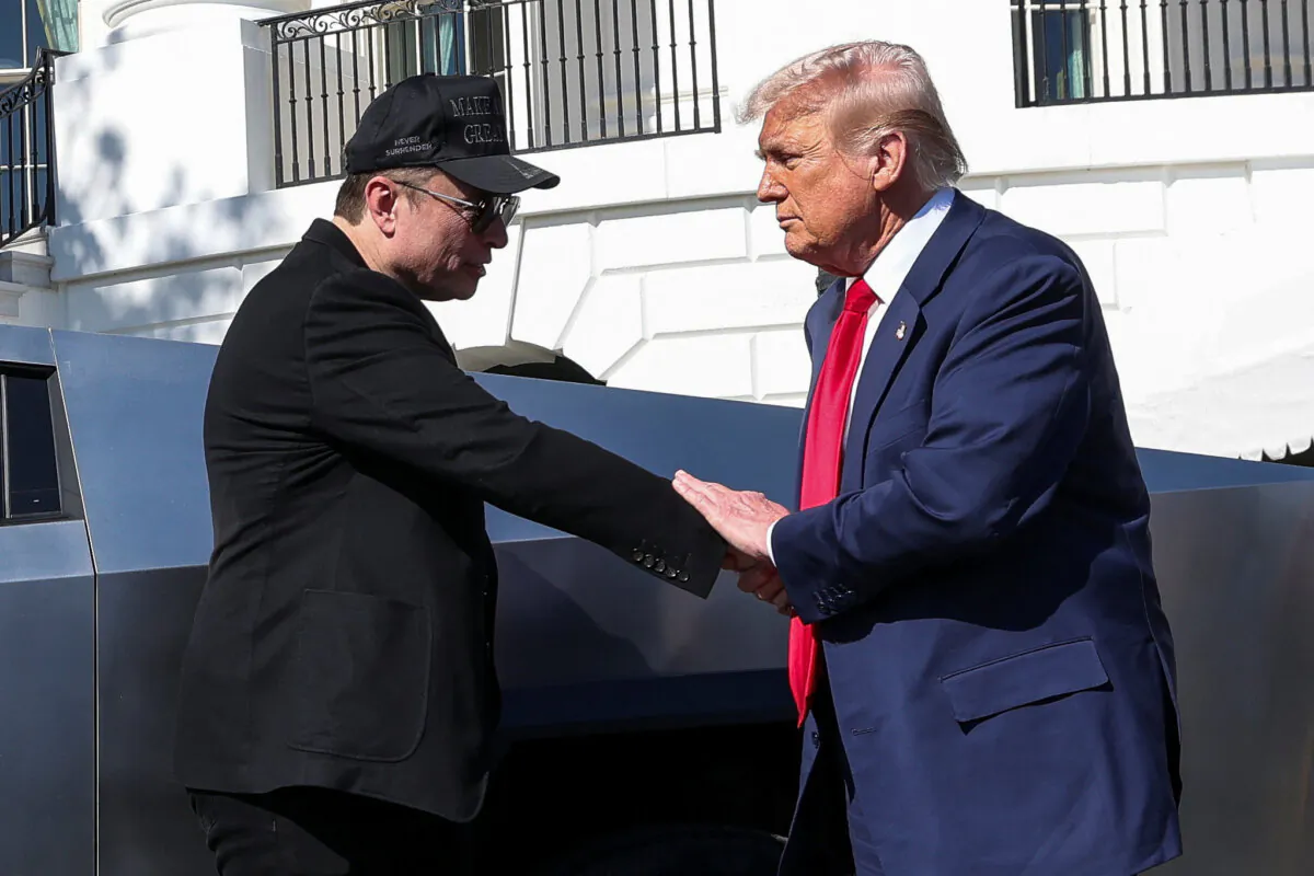 U.S. President Donald Trump and Tesla CEO Elon Musk shake hands in front of a Tesla Cybertruck, at the White House in Washington on March 11, 2025. (Kevin Lamarque/File Photo/Reuters)