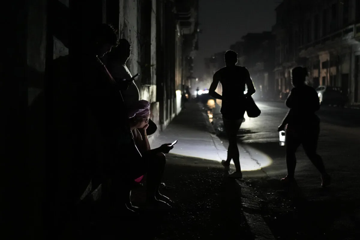 Residents walk on a street during a general blackout in Havana, Cuba, on March 14, 2025. (Ramon Espinosa/AP Photo)