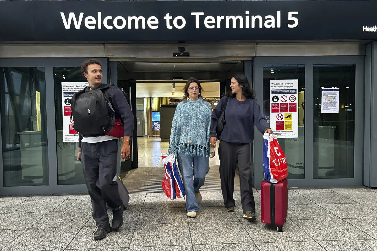 Travellers arrives at Terminal 5 as Heathrow Airport slowly resumes flights after a fire cut power to Europe's busiest airport in London on March 22, 2025. (Kirsty Wigglesworth/AP Photo)