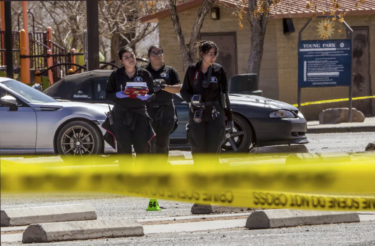 Crime scene technicians investigate in the parking lot at Young Park after a fatal shooting in Las Cruces, N.M., on March 22, 2025. (Chancey Bush/The Albuquerque Journal via AP)
