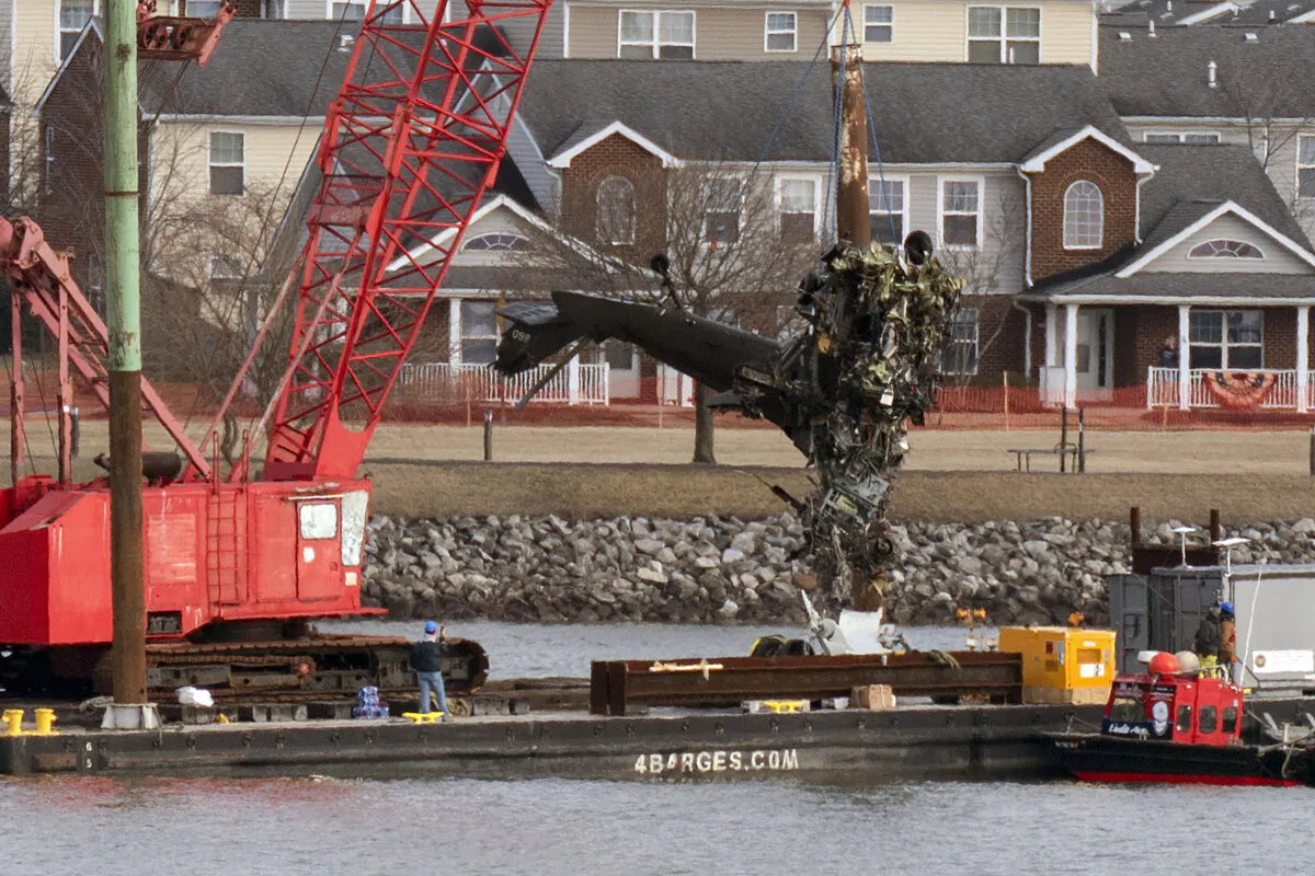 Salvage crews pull up a part of an Army Black Hawk helicopter that collided with an American Airlines jet near Ronald Reagan Washington National Airport, on Feb. 6, 2025. (Jose Luis Magana/AP Photo)