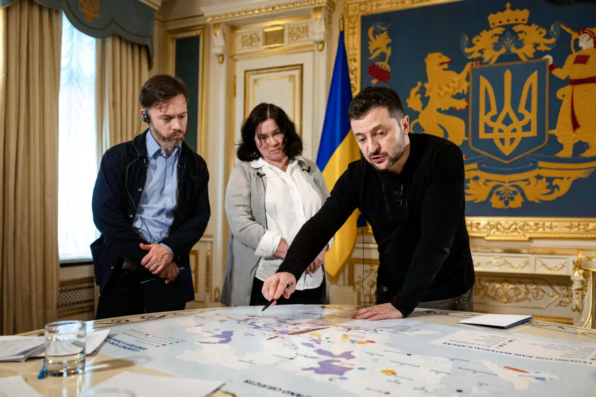 Ukrainian President Volodymyr Zelenskyy shows Reuters journalists a map of strategic resources at his office in Kyiv, Ukraine, on Feb. 7, 2025. The United States and Ukraine signed a long-delayed minerals deal on April 30. (Alentyn Ogirenko/Reuters)