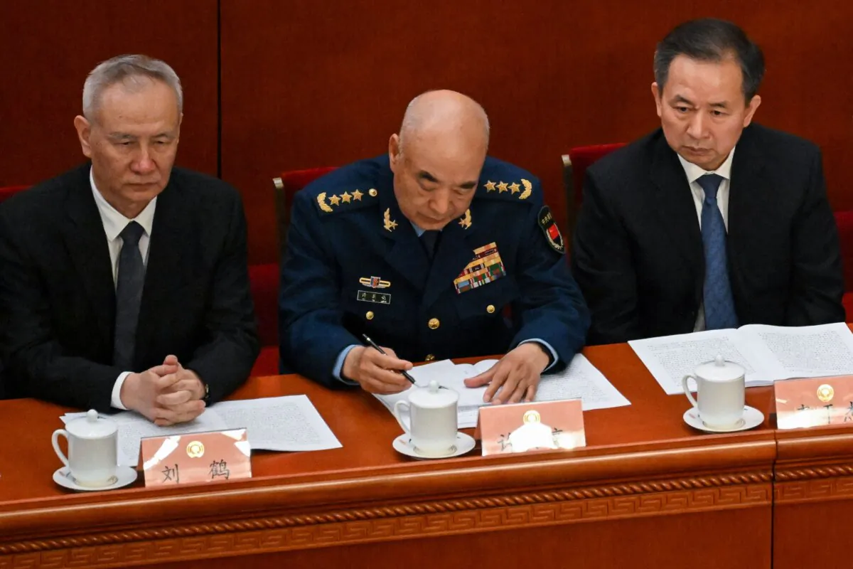 (L–R) Chinese Vice Premier Liu He, Vice Chairman of China's Central Military Commission Xu Qiliang, and Communist Party of China Central Committee Political Bureau member Li Ganjie attend the opening ceremony of the Chinese People's Political Consultative Conference at the Great Hall of the People in Beijing on March 4, 2023. (Noel Celis/AFP via Getty Images)
