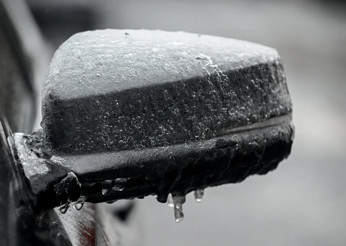 Ice is shown on the side mirror of a car in Montreal, on March 30, 2025. (The Canadian Press/Graham Hughes)