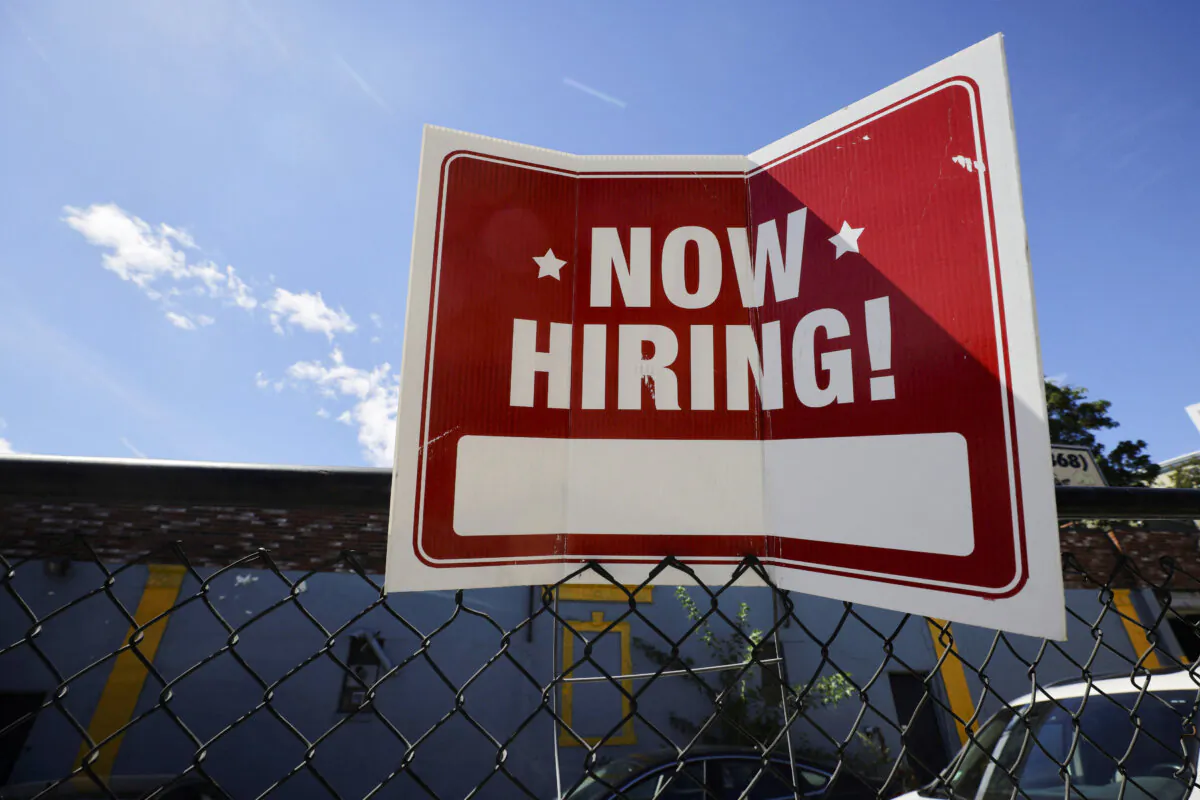 A "Now Hiring" sign outside Taylor Party and Equipment Rentals in Somerville, Mass., on Sept. 1, 2022. (Brian Snyder/Reuters)