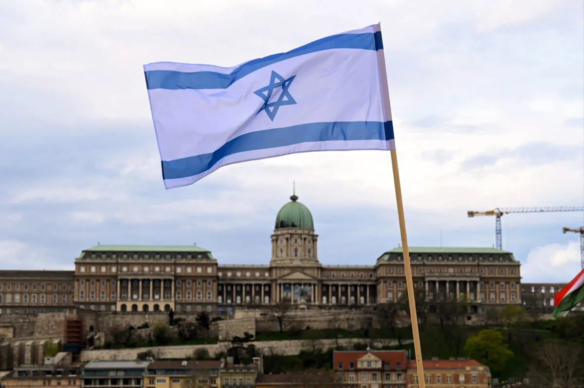 An Israeli National flag is raised on the oldest Hungarian bridge, the Szechenyi Chain Bridge, as in the background can be seen the Buda Castle in Budapest on April 2, 2025. (Attila Kisbenedek/ AFP via Getty Images)
