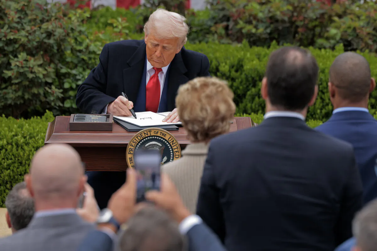 President Donald Trump signs executive orders raising tariffs on products made in foreign countries during a “Make America Wealthy Again” event in the Rose Garden at the White House on April 2, 2025. (Chip Somodevilla/Getty Images)