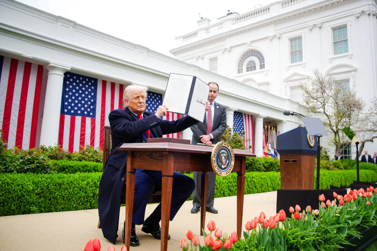 President Donald Trump holds a signed executive order on reciprocal tariffs during an event in the Rose Garden at the White House on April 2, 2025. (Saul Loeb/AFP via Getty Images)